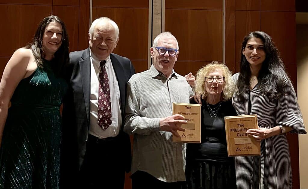 Group of people smiling on stage
